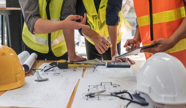 Engineer,Teamwork,Meeting,,Drawing,Working,On,Blueprint,Meeting,For,Project